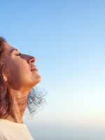 Young,Woman,Breathing,Fresh,Air,With,Closed,Eyes,And,Serene