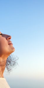 Young,Woman,Breathing,Fresh,Air,With,Closed,Eyes,And,Serene