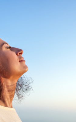 Young,Woman,Breathing,Fresh,Air,With,Closed,Eyes,And,Serene