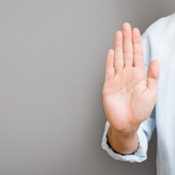 Faceless,Man,In,Shirt,Showing,Stop,Hand,Sign,Standing,On